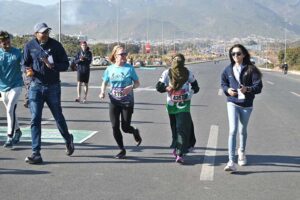 A woman reached the finishing line as a large number of people participated in the Islamabad Marathon 2025 organized by “Islamabad Run with Us