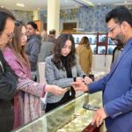 A family viewing jewelry at the Damas Jewelry Exhibition, at (SOM), Living Dreams Marquee, Sialkot Cantt