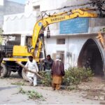 Municipal Corporation workers trees are being cut down to widen at the Eid Gah Road