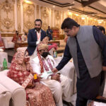 Pakistan Muslim League (N) MPA Taimur Khan Baloch is distributing ATM cards to newly married couples on the occasion of mass marriages under the "Dhi Rani Program" by Chief Minister Punjab at local hotel