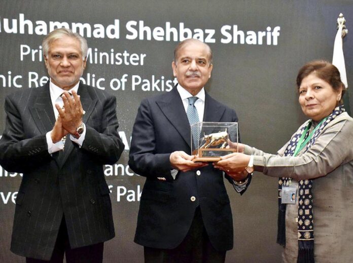 Prime Minister Muhammad Shehbaz Sharif receives a souvenir from Chairperson PSE Ms. Shamshad Akhtar during his visit to Pakistan Stock Exchange