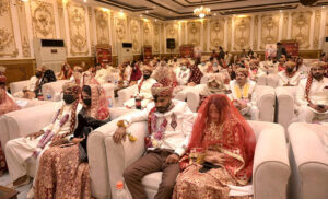 Pakistan Muslim League (N) MPA Taimur Khan Baloch is distributing ATM cards to newly married couples on the occasion of mass marriages under the "Dhi Rani Program" by Chief Minister Punjab at local hotel