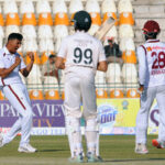 West Indies' Kevin Sinclair celebrate with teammates after taking the wicket of Pakistan's Babar Azam during the second day of the second Test cricket match between Pakistan and West Indies at the Multan Cricket Stadium