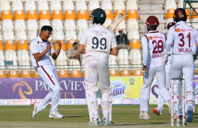 West Indies' Kevin Sinclair celebrate with teammates after taking the wicket of Pakistan's Babar Azam during the second day of the second Test cricket match between Pakistan and West Indies at the Multan Cricket Stadium