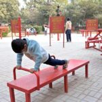 A child having a great time at the open-air gym in Company Bagh