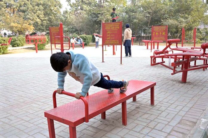 A child having a great time at the open-air gym in Company Bagh