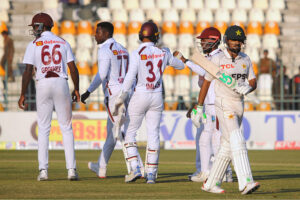 West Indies' Kevin Sinclair celebrate with teammates after taking the wicket of Pakistan's Babar Azam during the second day of the second Test cricket match between Pakistan and West Indies at the Multan Cricket Stadium