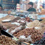 A vendor arranges and displays a variety of dry fruits at his shop as demand surges after dropping the temperature in the metropolis