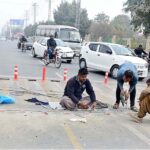 Electricians busy laying the wire of the traffic signal at Eid Gah Chowk