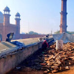 Laborers busy restoration work at Badshahi Masjid