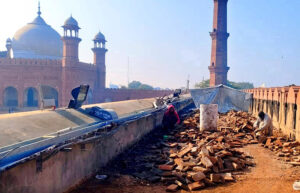 Laborers busy restoration work at Badshahi Masjid