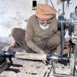 Laborers busy in making parts of traditional bed (Charpai) at their workplace in the Ichara Furniture market