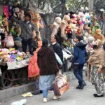 People busy selecting and purchasing second-hand toys from the vendors at weekly Bazaar