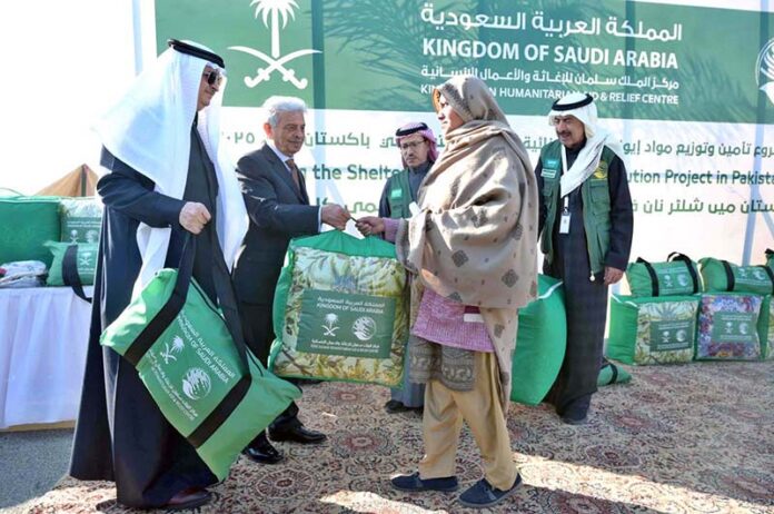 Federal Minister for National Food Security and Research, Rana Tanveer Hussain giving away relief kits to the deserving families as KSrelief launches major initiative to provide shelter NFIs and Winter Kits in Pakistan 2025 at Pakistan Sports Complex with Saudi Ambassador Nawaf Bin Said Al-Maliki