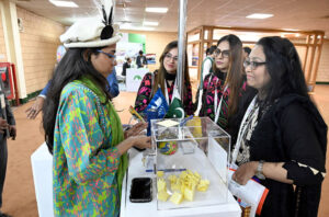 Women Visitor taking interest at Hotels & Resorts Pavilion stall during the Pakistan Travel Mart (PTM) 2025 at Expo Centre