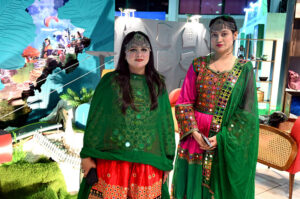 Women Visitor taking interest at Hotels & Resorts Pavilion stall during the Pakistan Travel Mart (PTM) 2025 at Expo Centre