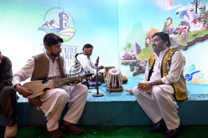 Women Visitor taking interest at Hotels & Resorts Pavilion stall during the Pakistan Travel Mart (PTM) 2025 at Expo Centre