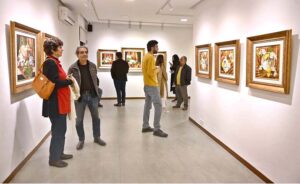 A visitor capturing picture with the on displayed artwork at exhibition “A Spring Reverie - Petals & Porcelain” by talented still life artist, Irfan Cheema in Tanzara Gallery