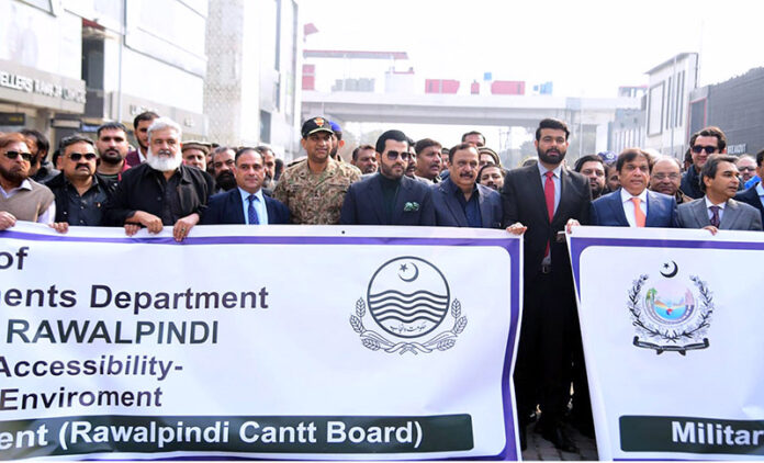Barrister Danyal Chaudhry, Parliamentary Secretary for Information and Broadcasting, leading a walk on Bank Road, Saddar, to highlight the city's first walking street project aimed at enhancing pedestrian-friendly spaces