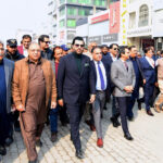 Barrister Danyal Chaudhry, Parliamentary Secretary for Information and Broadcasting, leading a walk on Bank Road, Saddar, to highlight the city's first walking street project aimed at enhancing pedestrian-friendly spaces
