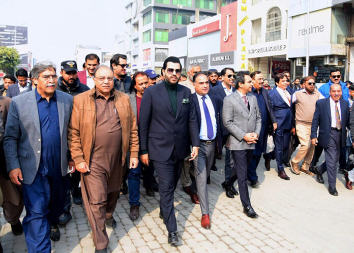 Barrister Danyal Chaudhry, Parliamentary Secretary for Information and Broadcasting, leading a walk on Bank Road, Saddar, to highlight the city's first walking street project aimed at enhancing pedestrian-friendly spaces
