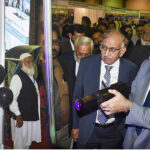 Sindh Chief Minister Syed Murad Ali Shah aims a laser gun at a balloon during his visit to a stall at the 4th Research & Technology Showcase 2025, organised by the Sindh Higher Education Commission (Sindh HEC) at Expo Center