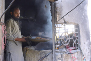 A vendor busy cleaning grams at his shop