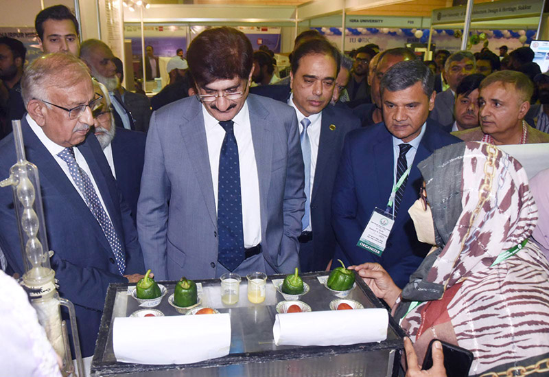 Sindh Chief Minister Syed Murad Ali Shah aims a laser gun at a balloon ...