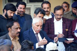 Federal Minister for Maritime Affairs, Qasir Ahmad Sheikh, attentively listening to people's concerns during an Open Court session at his residence.