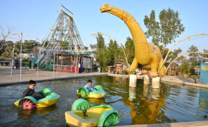 Children enjoy boat riding at Funland Rani Bagh.