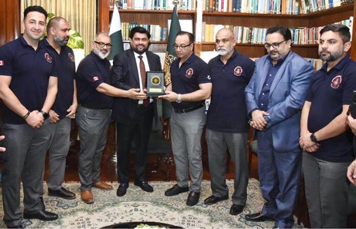 Governor Sindh, Kamran Tessori presents a shield to the president and CEO of the Canadian Police Cricket Club during their visit to the Governor House in the provincial capital