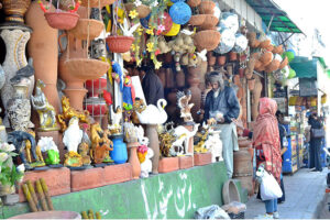 A woman shopping for rare decorative items made of clay at Ferozpur Road.