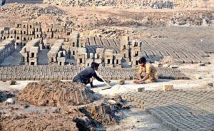 Young workers preparing bricks at a local bricks kiln.