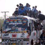 A large number of students traveling in a dangerous way on rooftop of passenger bus may cause any mishap and needs the attention of concerned authorities