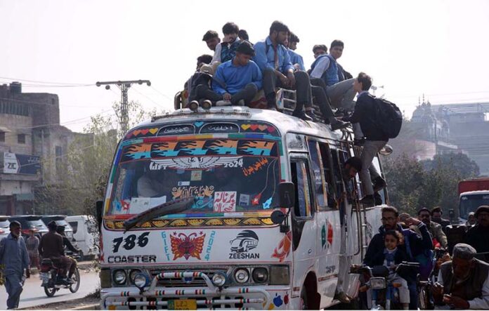 A large number of students traveling in a dangerous way on rooftop of passenger bus may cause any mishap and needs the attention of concerned authorities