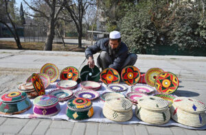 A vendor arranging and displaying handmade items to attract the customers in Federal Capital.