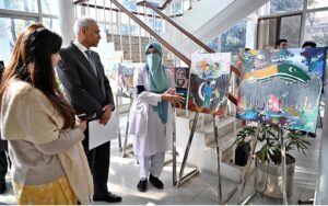 Executive Director General of DEMP Mubashir Tauqeer cutting ribbon to inaugurate Digital Photographic and Painting Exhibition organized by Directorate of Electronic Media and Publications, Ministry of Information and Broadcasting in connection with Kashmir Solidarity Day at Information Service Academy.