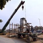 Labourers busy in construction work of flyover at under construction 10th Avenue during development work in Federal Capital