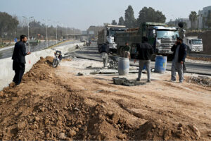Labourers busy in construction work of Serena Chowk Interchange Project during development work in the Federal Capital