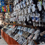 A vendor displaying shoes on his shop to attract costumers near Raja Bazar