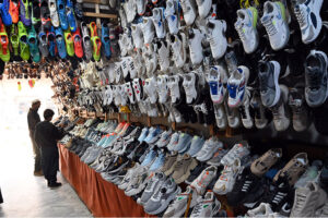 A vendor displaying shoes on his shop to attract costumers near Raja Bazar