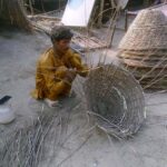 Artisan busy preparing baskets at his workplace