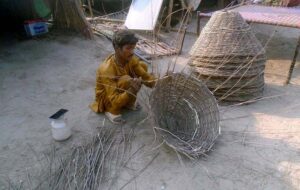 Artisan busy preparing baskets at his workplace