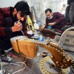 Workers busy in making traditional musical instrument (Rabab) at his workplace near Dabgari area