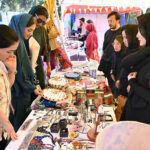 Women visiting stalls during Faiz Mela at Al-Hamra