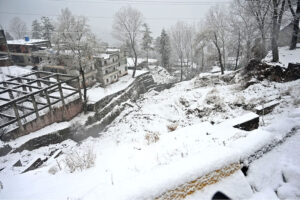 A beautiful view of road covered with snow during a heavy morning snowfall in the city.