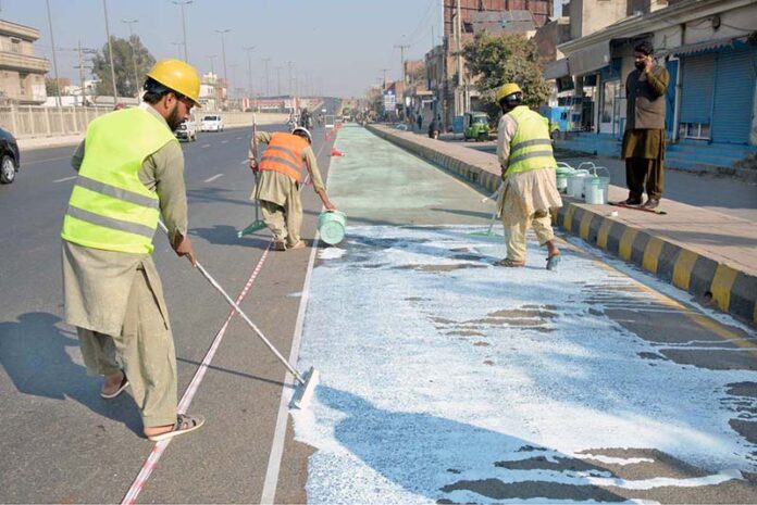 Labourers are busy preparing the green tracks for motorcyclists at the General Bus Stand