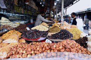 A vendor displays a variety of fruits, commonly used in fruit salads, a staple on the menu for breaking fast during the holy month of Ramdan, attracting customers at H-9 Weekly Bazar.