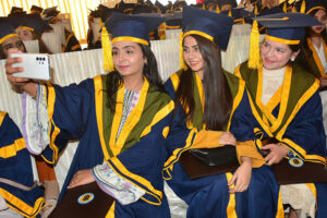 Successful graduate students showing their degrees during 22nd convocation of ISRA University