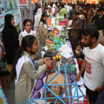 People visit stalls of science fair during Sindh Sufi Melo at Sindh museum